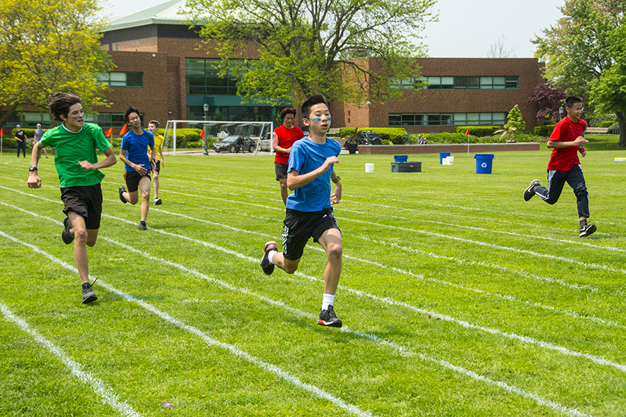 Photo of students running on field on sports day