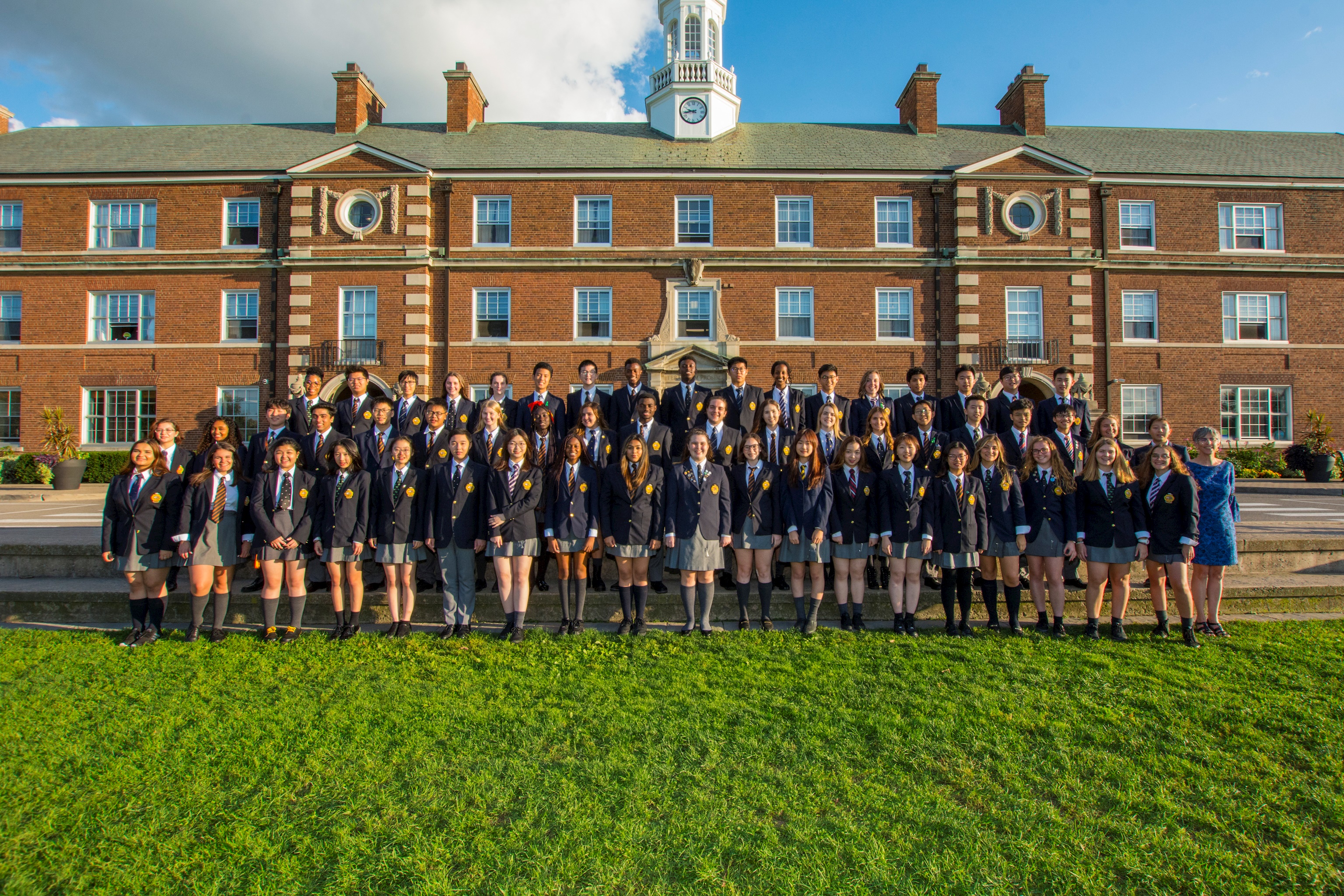 class photo of the upper school outide the main school building