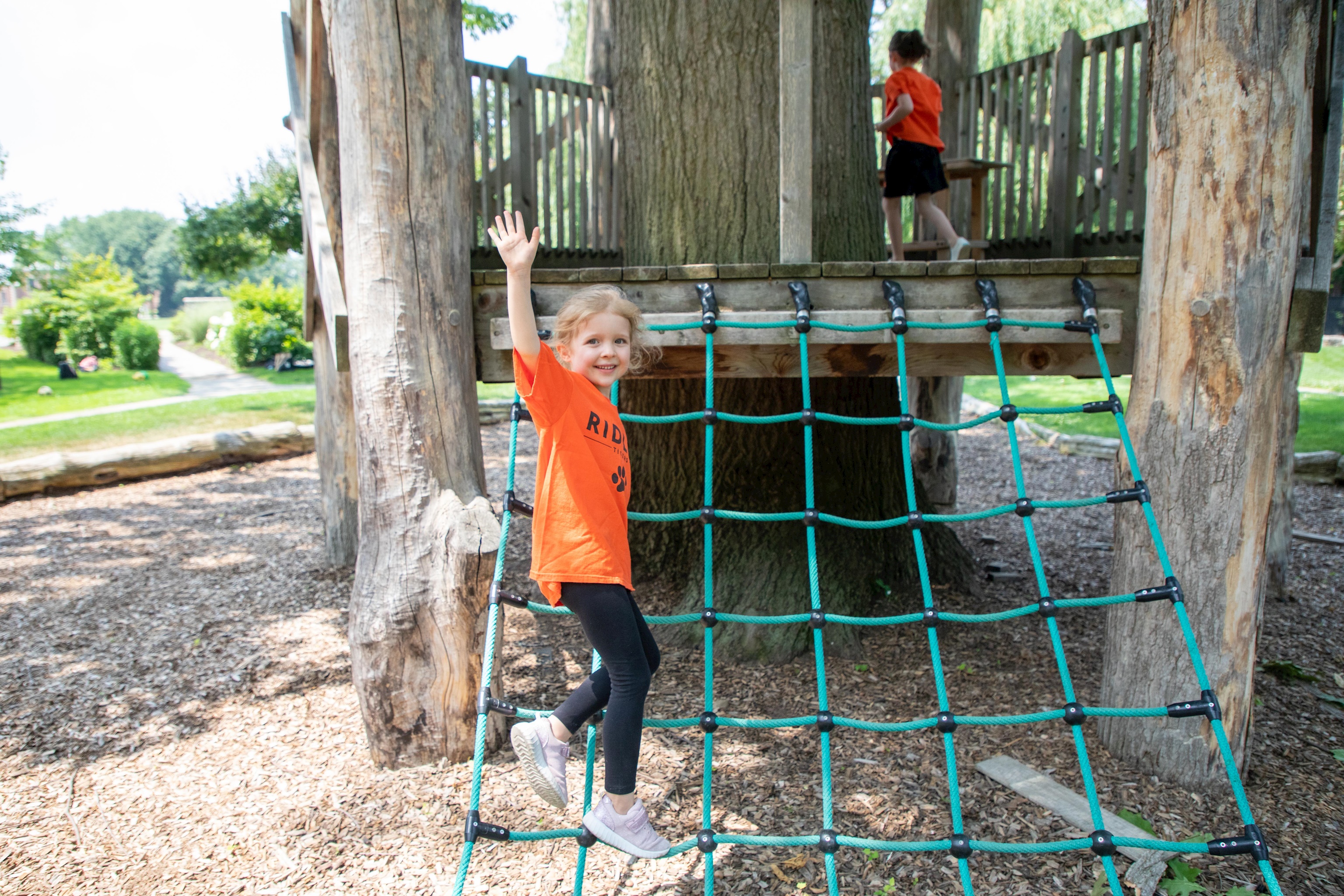 Photo of lower school student on jungle gym equipment