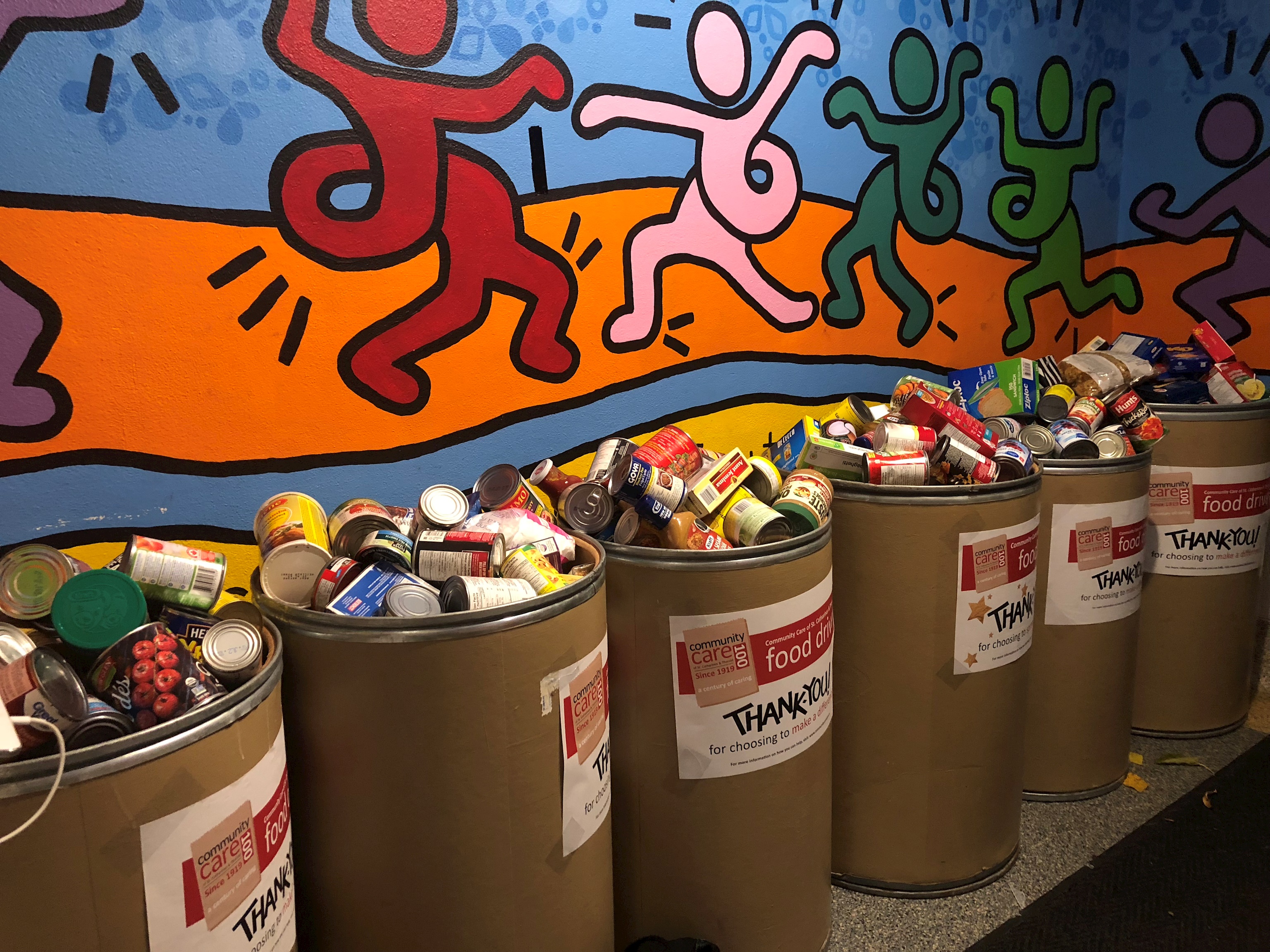 Photo of tins added to bins for service collection